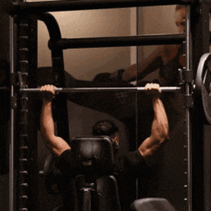 Man doing behind the neck smith