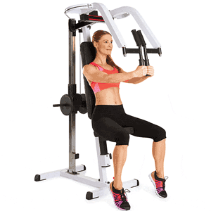 Woman exercising on a pec deck