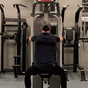 A person doing Reverse Pec Deck Flyes