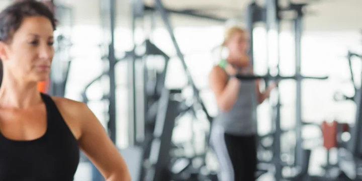 Woman flexing and working out at the gym