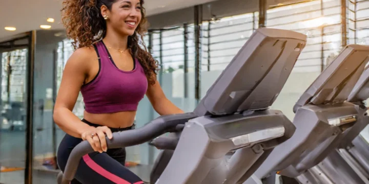 A young woman using a StairMaster at the gym for her workout