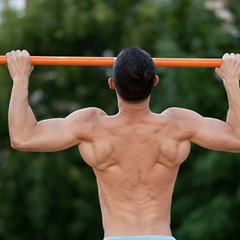 Man doing pull ups outdoors
