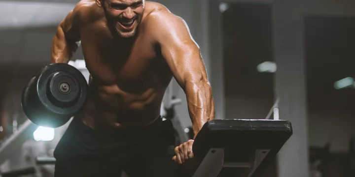 A person at the gym working out for body recomposition