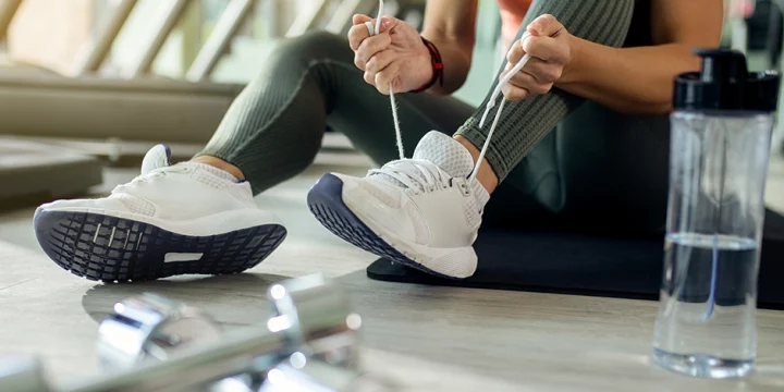 A close up shot of a woman wearing weightlifting shoes