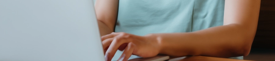 A person typing on laptop
