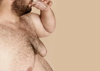 An overweight person in an isolated background