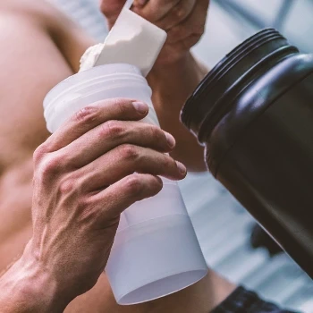 A man preparing a Creatine pre workout drink