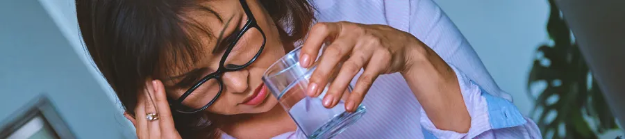 Woman pressing head for side effects
