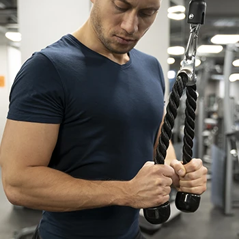 man working out triceps in the gym