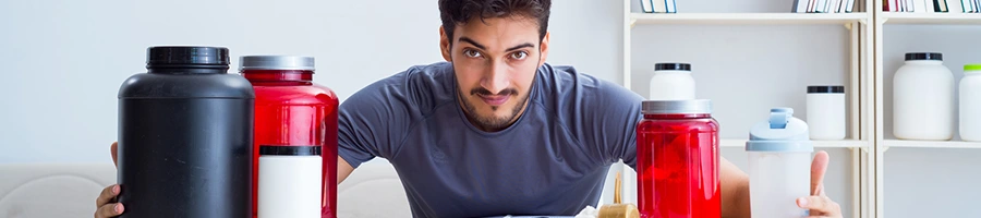 man with different protein powders