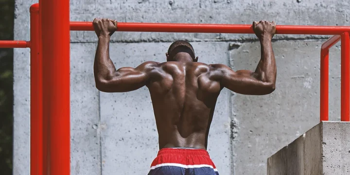 A person with good trap muscles working out outside