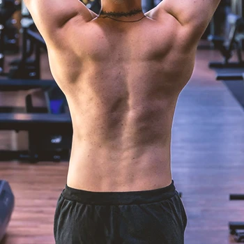 A person showing back and hips in the gym