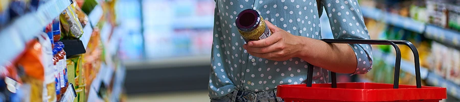 A woman shopping an organic pre workout supplement at a store