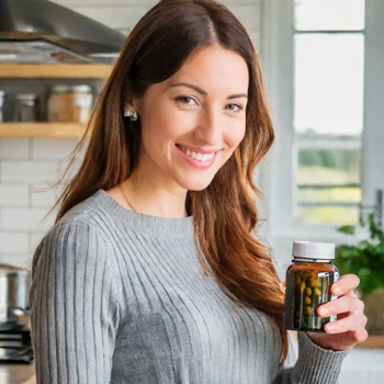 A woman holding a bottle containing different pills