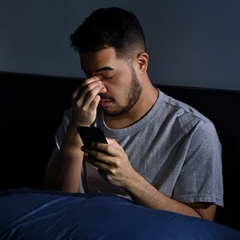A man experiencing insomnia as a side effect