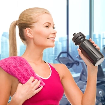 A woman who is about to drink from a shaker with BCAA
