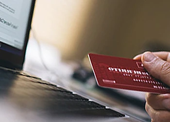 hand view of a person using card and pc