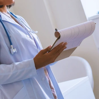 A doctor writing down who shouldn't take nootropic pills