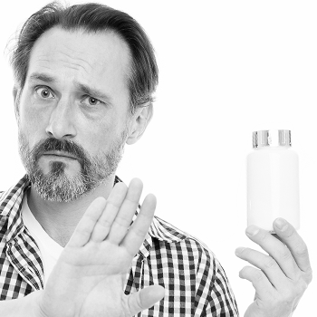 Man in white and black showing stop hand gesture